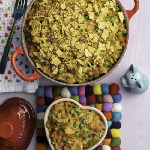 Vegan tuna casserole in a red Dutch oven with a small heart-shaped casserole next to it.