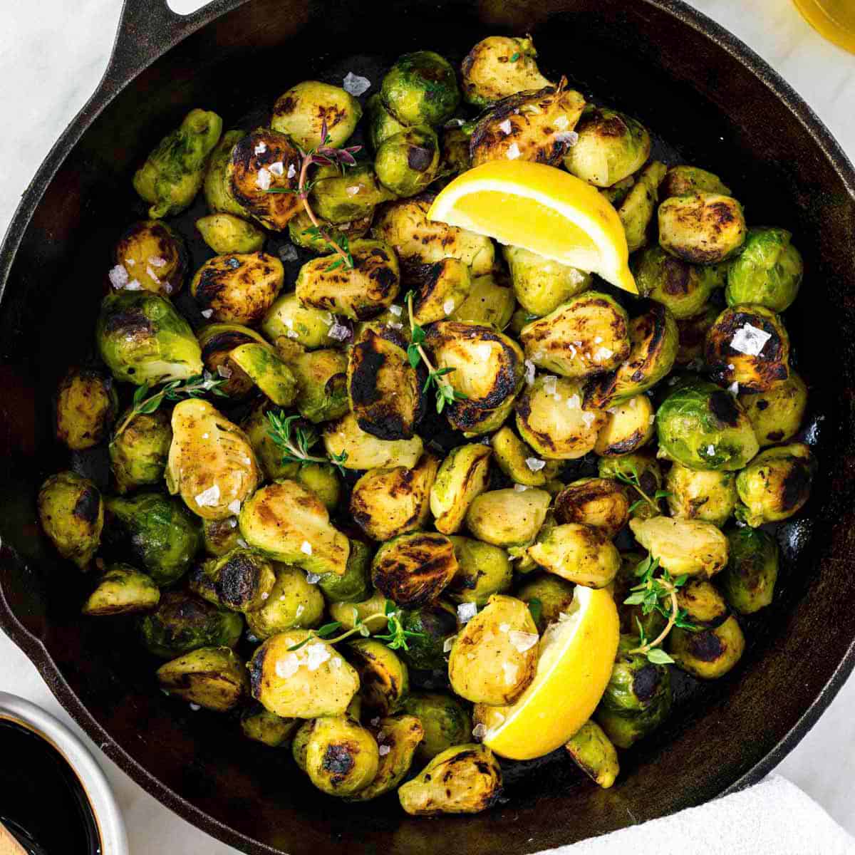 Frozen brussels sprouts cooked in a cast-iron skillet, and topped with flaky sea salt and fresh thyme.