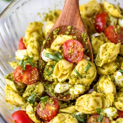 overhead of Pesto Tortellini Pasta Salad in a glass bowl.