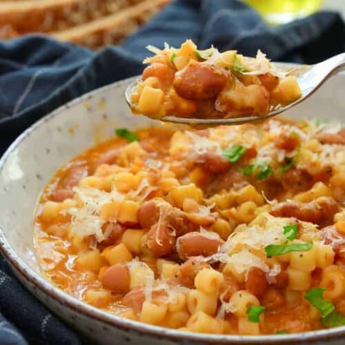 spoon with some vegan pasta fagioli on it over the bowl of the rest.