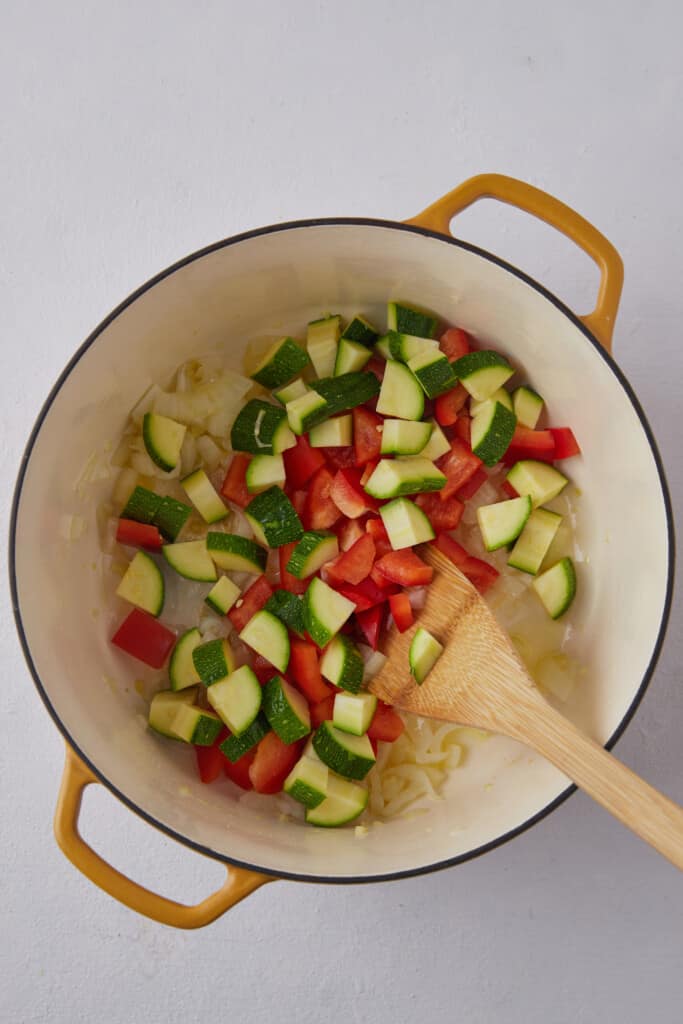 Zucchini and tomatoes in pot.