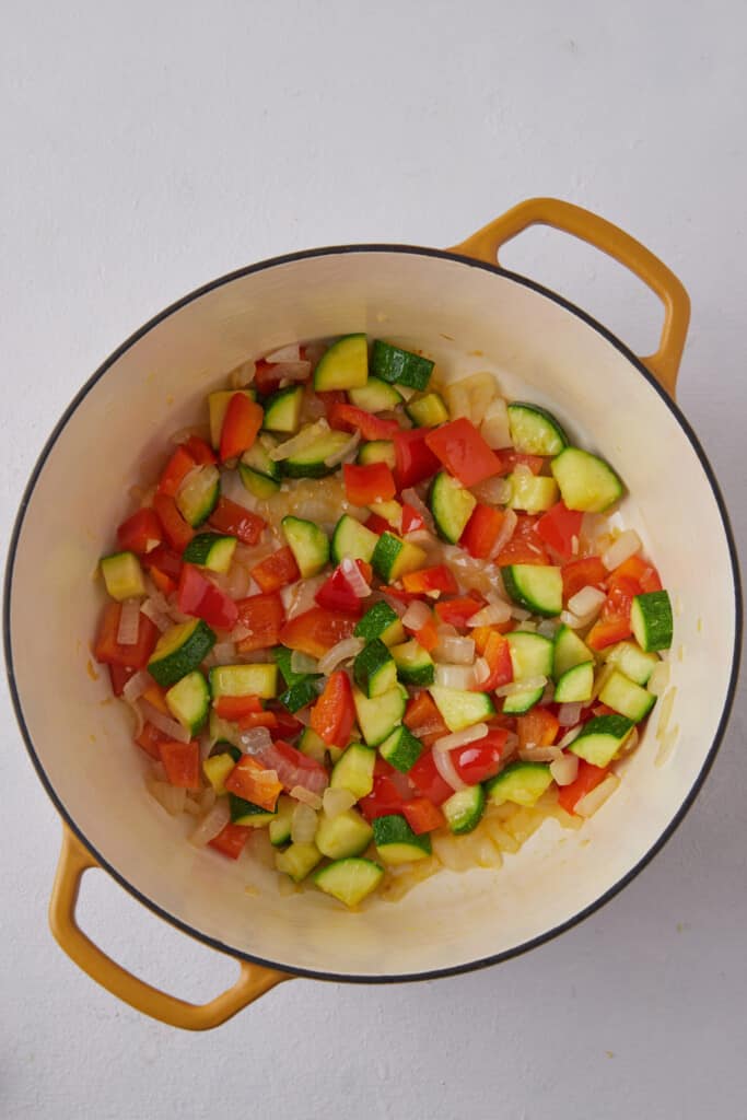 Softened veggies in pot.