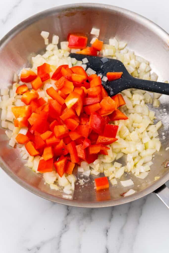 Onions and peppers in pan.