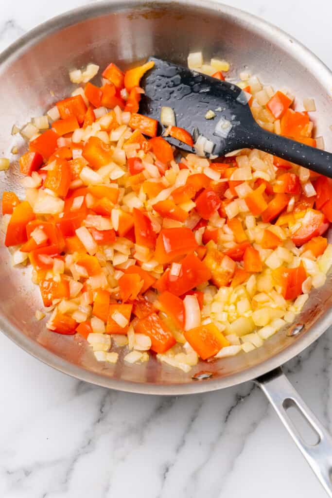 Cooked veggies with spatula.