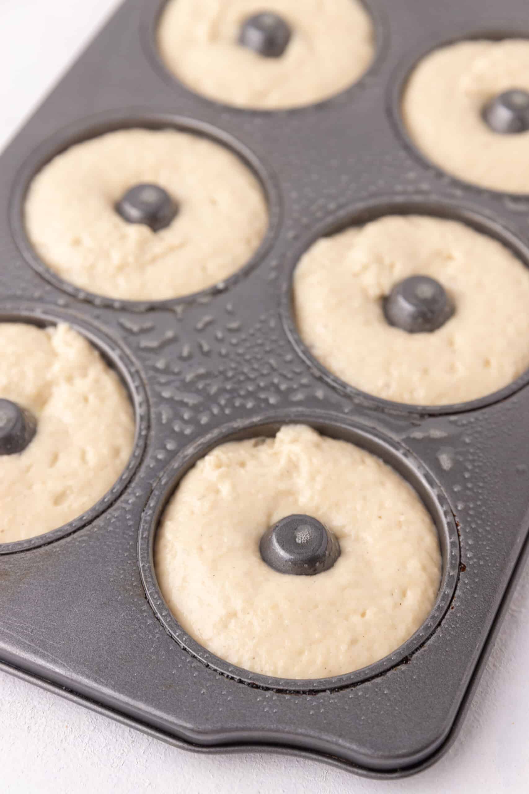 Raw donut batter in pan.