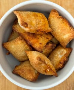 Air Fried Pizza Rolls or Pizza Bites in a bowl with cheese oozing out