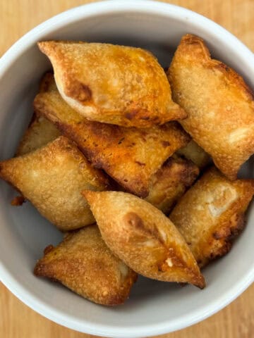 Air Fried Pizza Rolls or Pizza Bites in a bowl with cheese oozing out