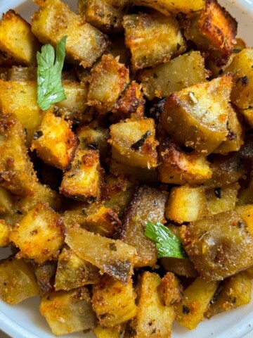 Air Fryer Sweet Potato Fries in a white bowl with cilantro garnish on top