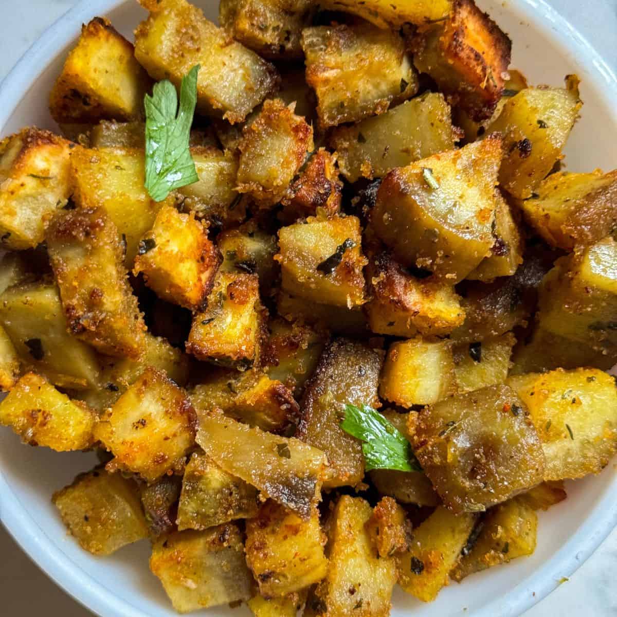 Air Fryer Sweet Potato Fries in a white bowl with cilantro garnish on top