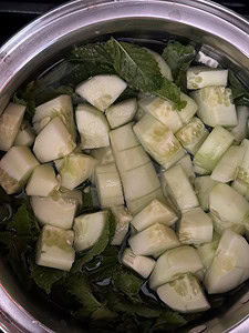 mint leaves and diced cucumber in saucepan