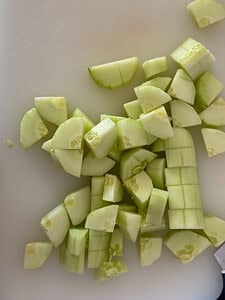 peeled and diced cucumbers on cutting board