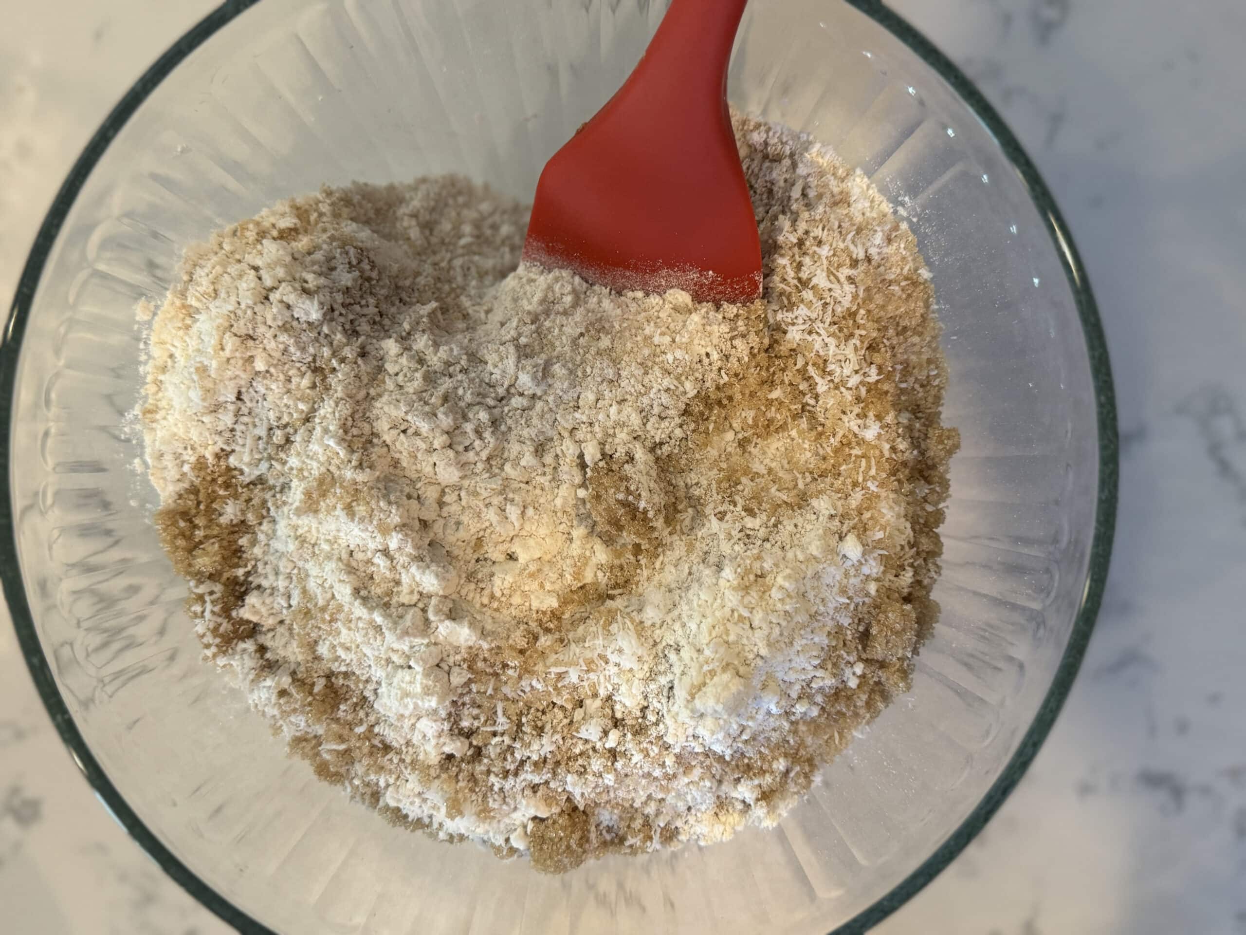 Dry Ingredients in a mixing bowl includes oatmeal, flour and sugar