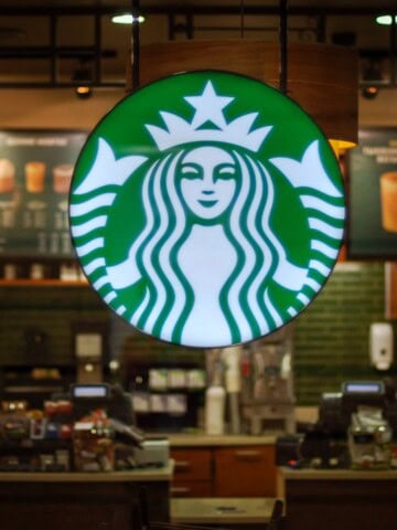 starbucks logo hanging outside coffee shop