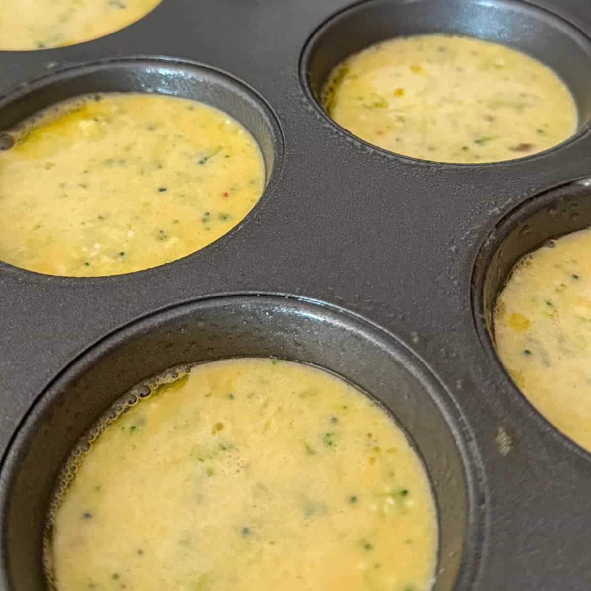 Step 2 of the step-by-step: Cottage Cheese Egg mixture poured into muffin pan