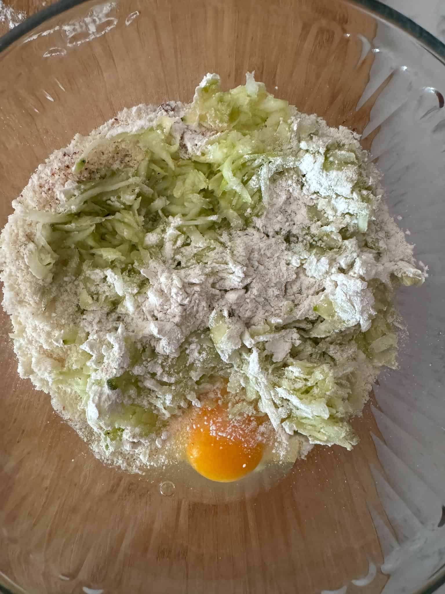 Egg Zucchini Squash Flour and Parmesan in a mixing bowl