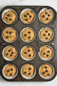 scooped batter in muffin baking pan