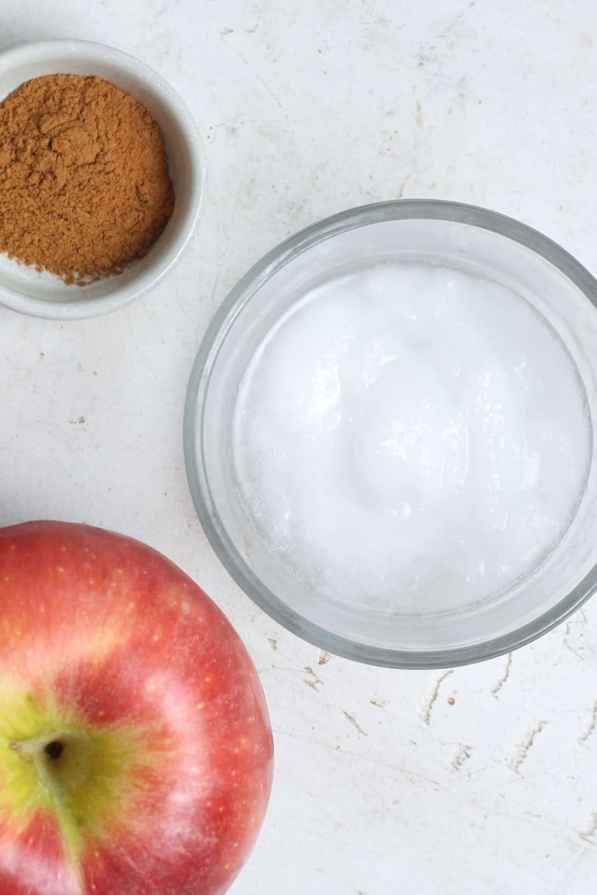 Ingredients laid out on a white background to make microwave cinnamon apples