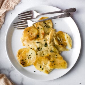 Dairy Free Scalloped Potatoes on a White Plate with two forks on the side