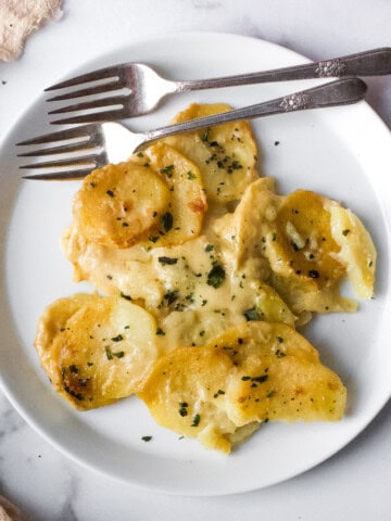 Dairy Free Scalloped Potatoes on a White Plate with two forks on the side